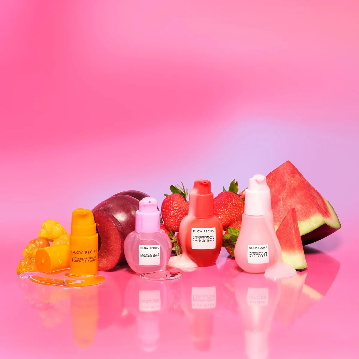 Glow Recipe Serum Superstars Set 2 Glow Recipe Serum Superstars bottles placed next to fresh watermelon strawberries plums and cloudberries.